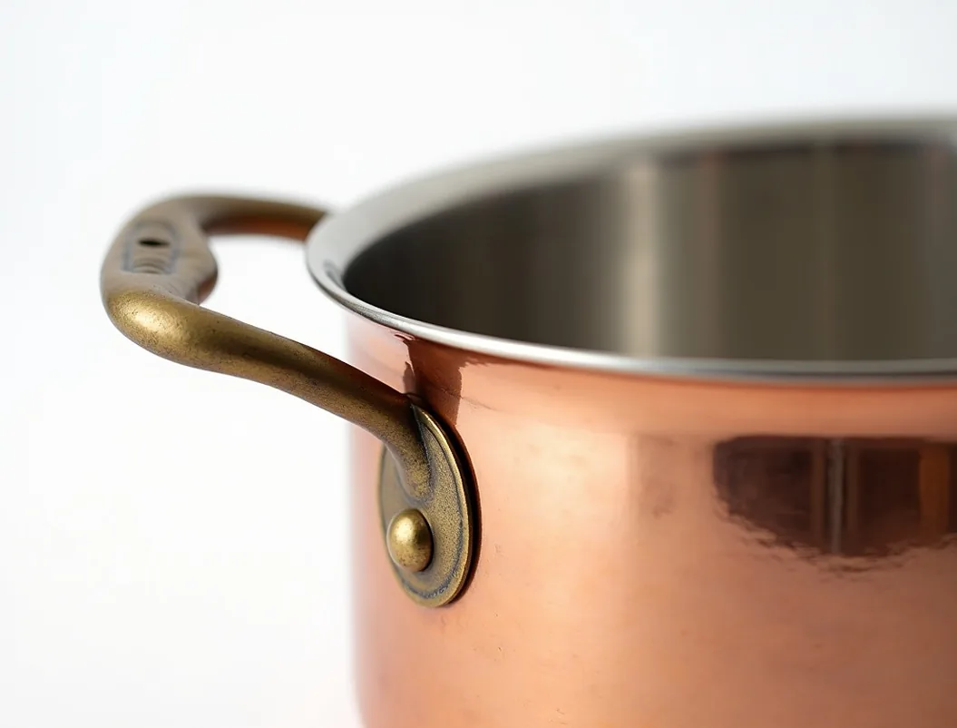 Copper casserole with stainless steel interior and cast bronze handles